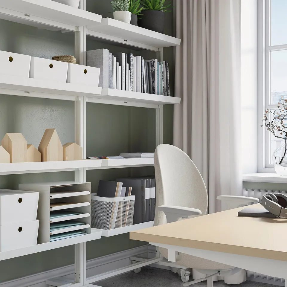 Modern office setup with MITTZON mobile shelf unit, white and light wood chair, desk with headphones, window.