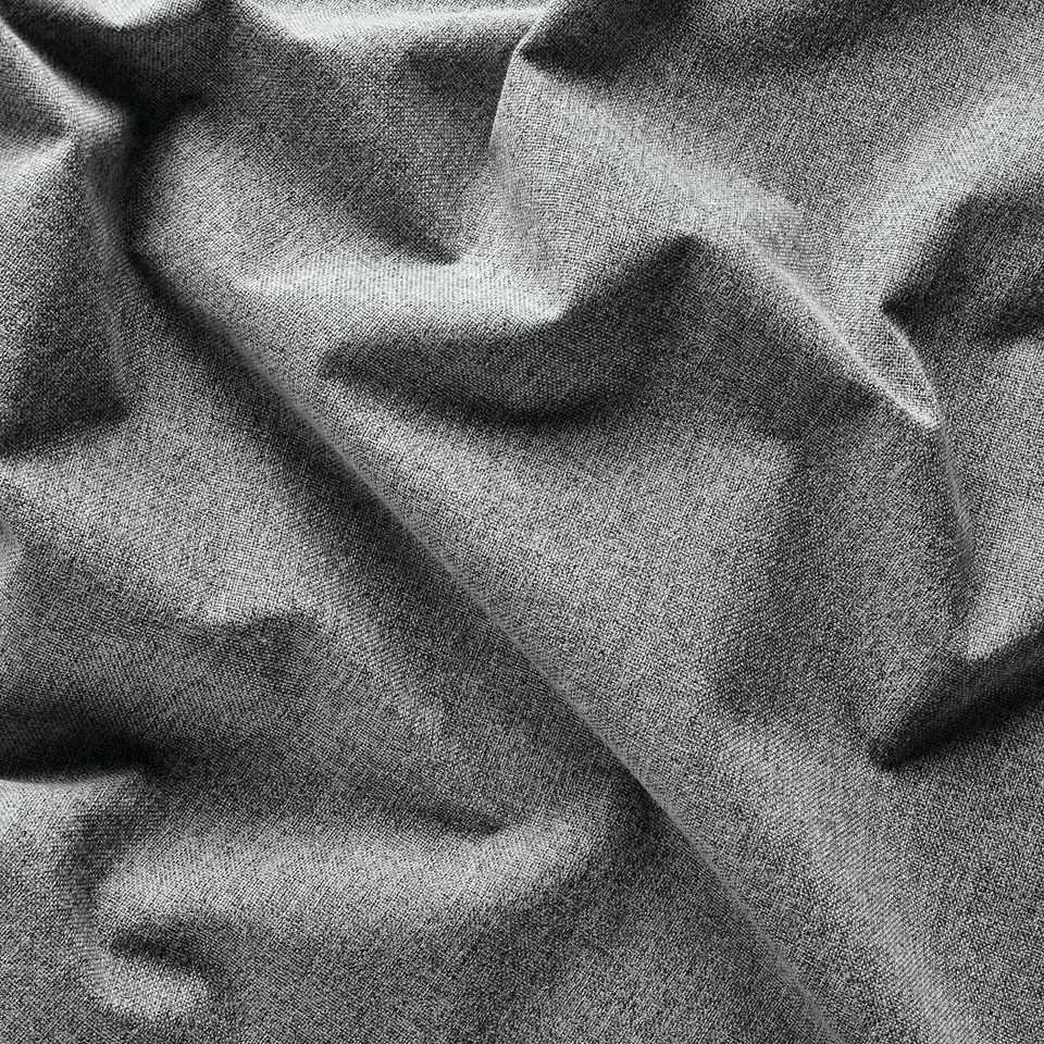 Soft, textured grey curtain close-up, showing intricate weave and gentle folds.