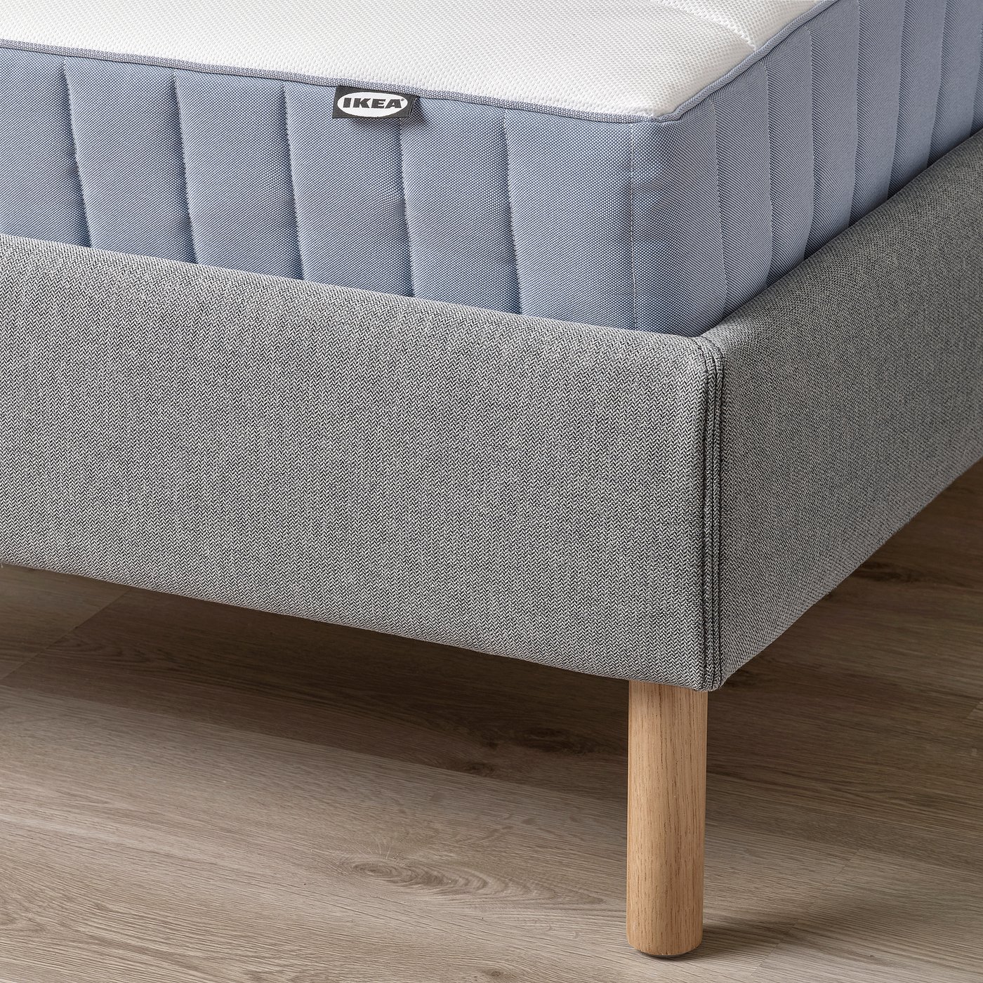 TÄRNKULLEN bed frame corner with padded headboard, removable cover, oak legs, and easy cleaning.
