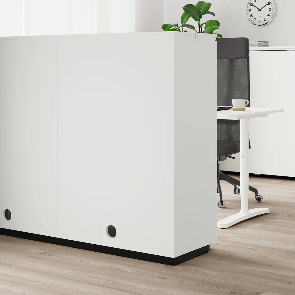 Office cabinet with adjustable feet, black handles, and shelves. Seamless office fit.