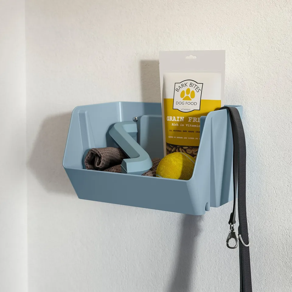 Blue wall-mounted organiser holding dog treats, leash, toy, and brush.