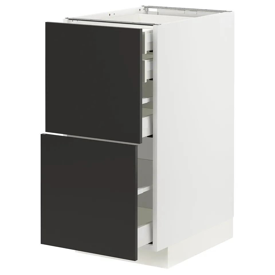 A modern white and black kitchen cabinet from the METOD system with pull-out drawers.