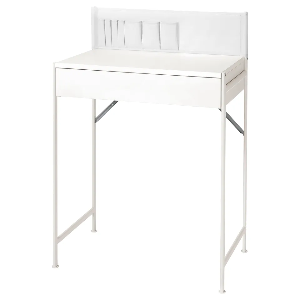A white BRUKSVARA dressing table with metal legs, a drawer, and fabric pockets on the back.