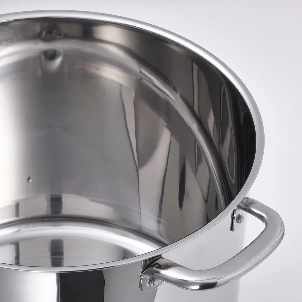 Stainless steel saucepan with two handles; reflects light evenly, robust construction, smooth interior.
