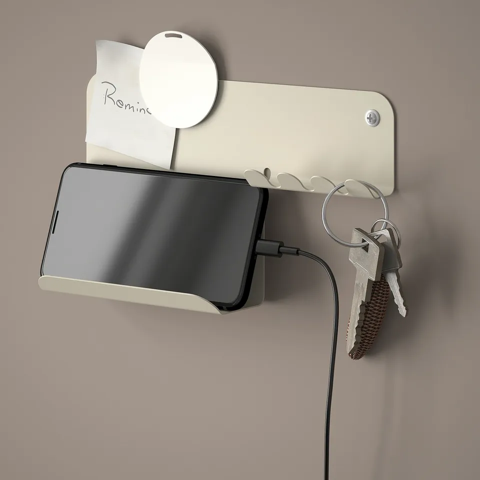 Wall organiser with phone charging, key holder, and note area.