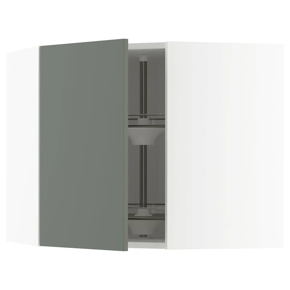 A modern kitchen cabinet with a grey-green door open, revealing adjustable shelves and a built-in carousel for organised storage.