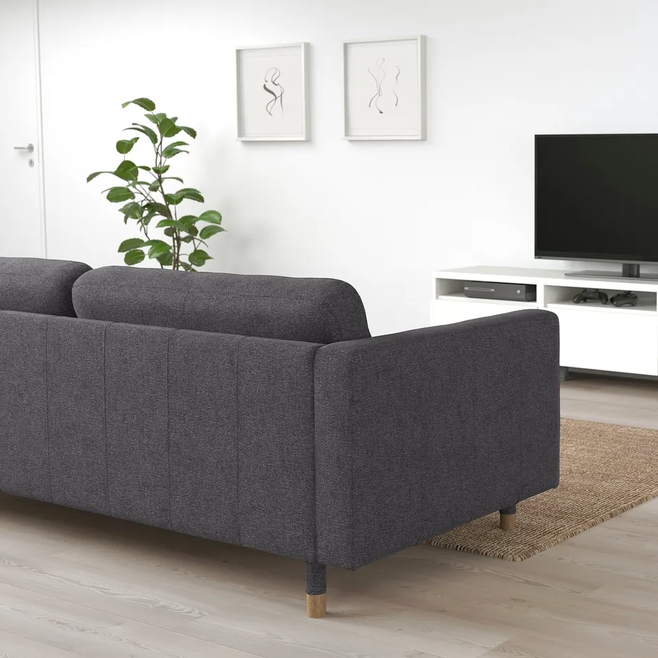 Modern living room with LANDSKRONA sofa, tv, plant, and minimalist decor.