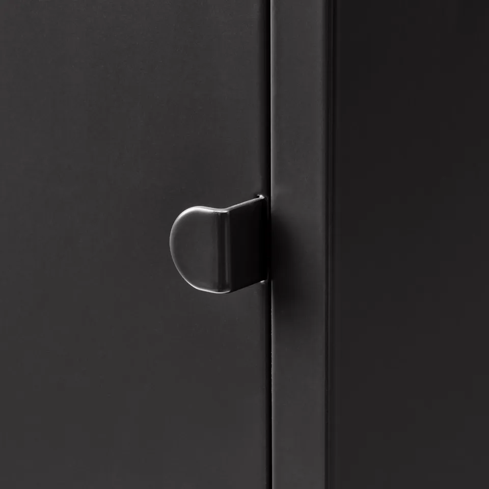 Black metal door handle, sleek and modern design, mounted on a smooth, dark surface.