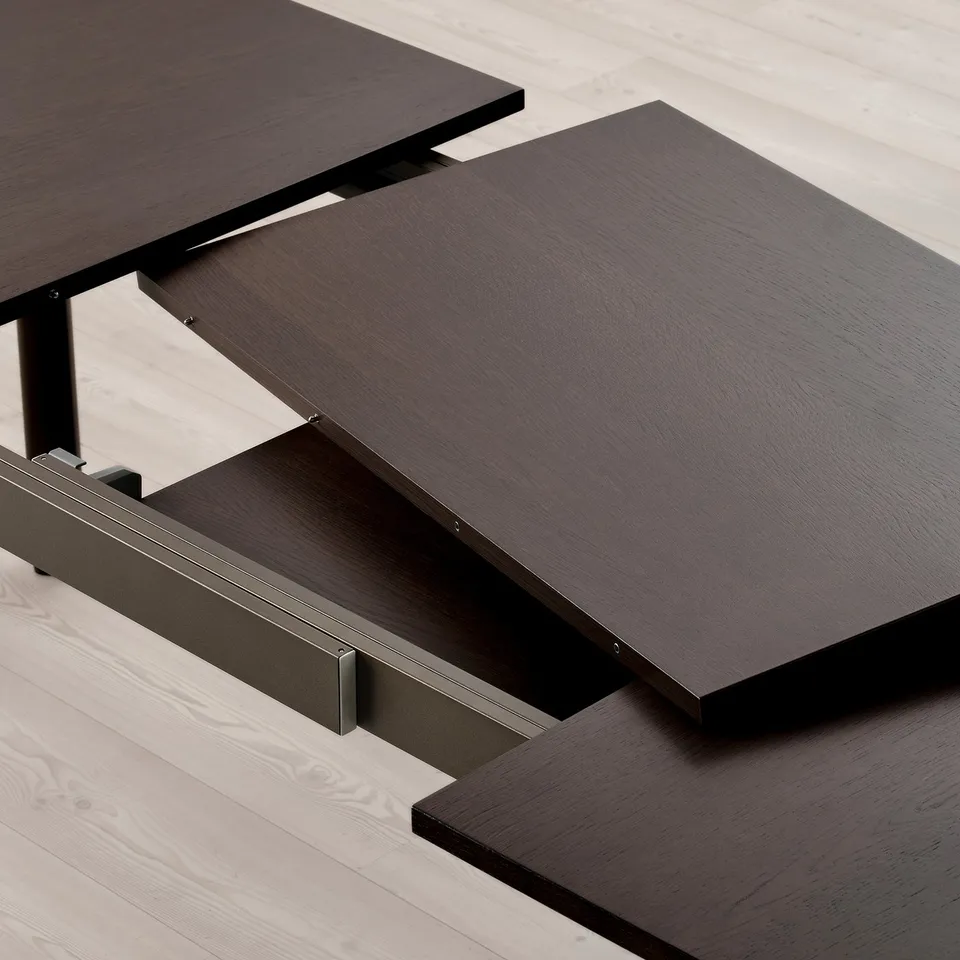 Dark wood dining table with two extendable leaves tucked underneath. Sturdy steel legs and underframe.