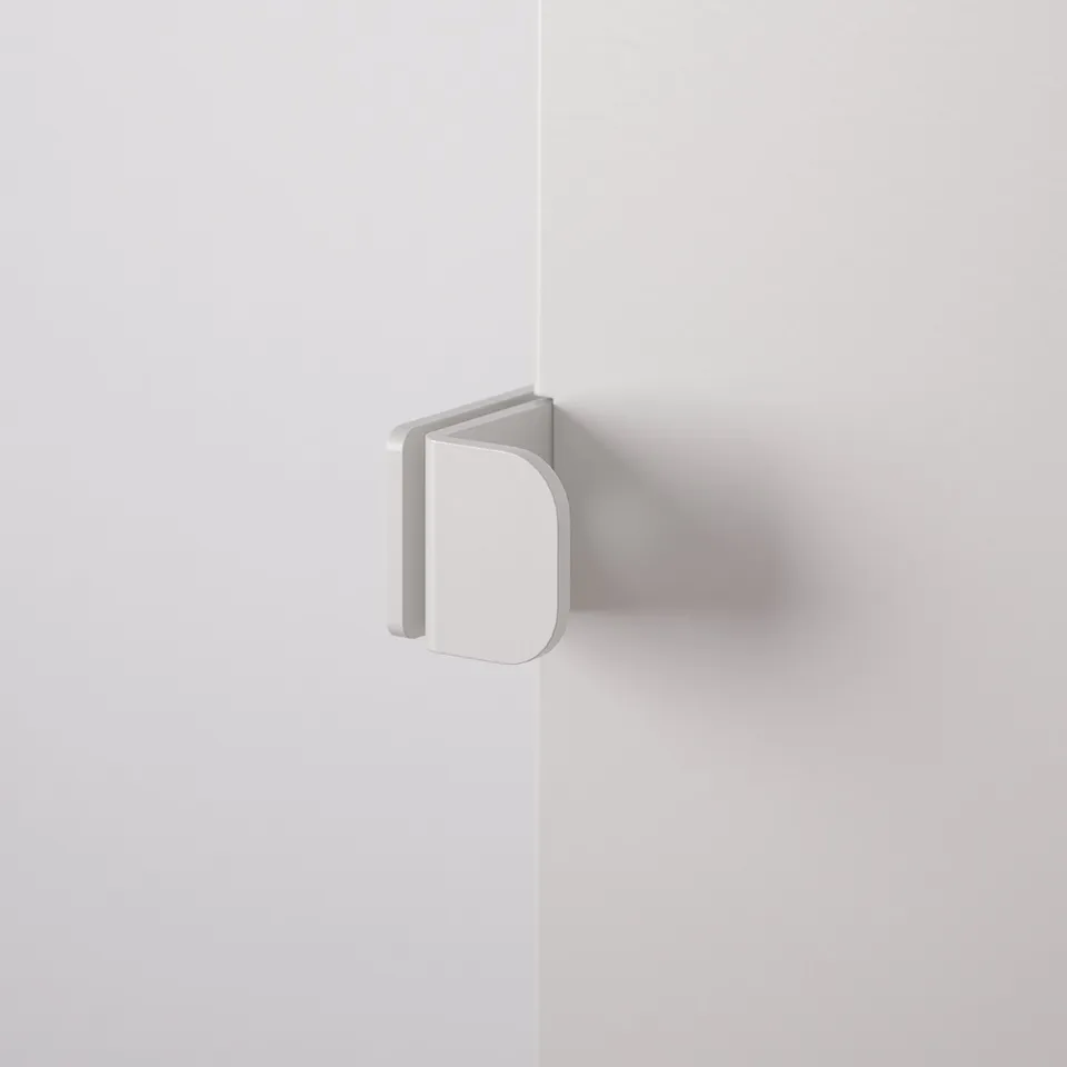 Wall-mounted, minimalist white shelf. Clean, sleek design, high-quality steel finish. Angled support adds stability.
