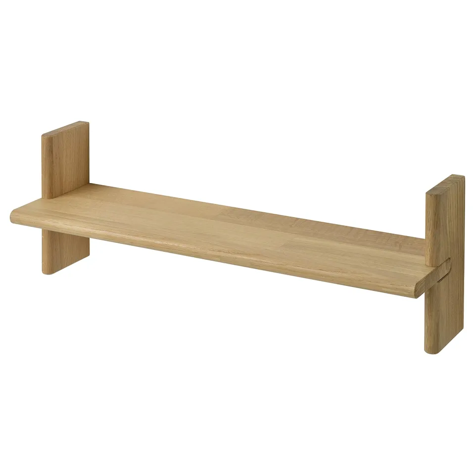 A KLAVRESTRÖM wooden shelf in natural oak. Its a simple, rectangular, wall-mounted design with two supports.