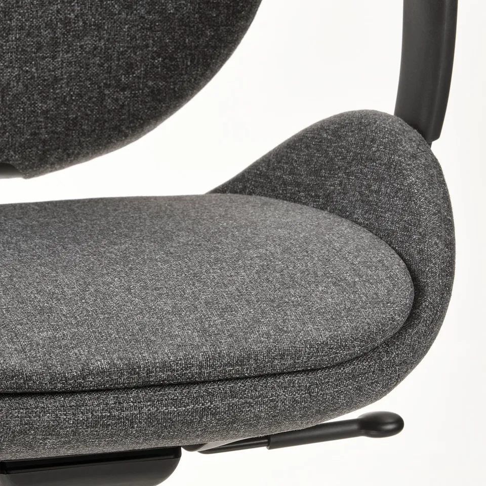 Close-up of modern office chair, showcasing ergonomic design, quality fabric, and sturdy armrest.