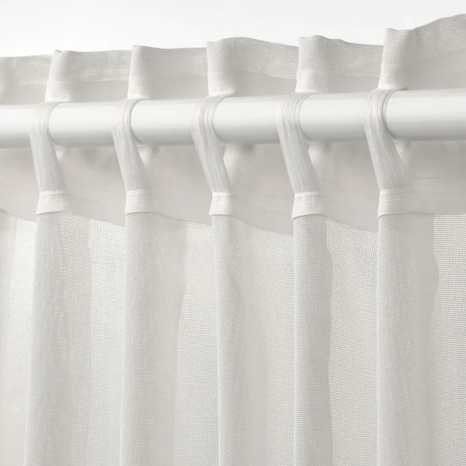 White sheer curtain with rod pockets, allowing light and shapes through, suitable for a layered window solution.