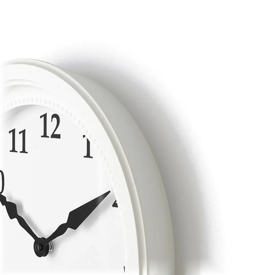 White wall clock with silent mechanism, black hands, numbers 11 and 1 visible, stylish design.