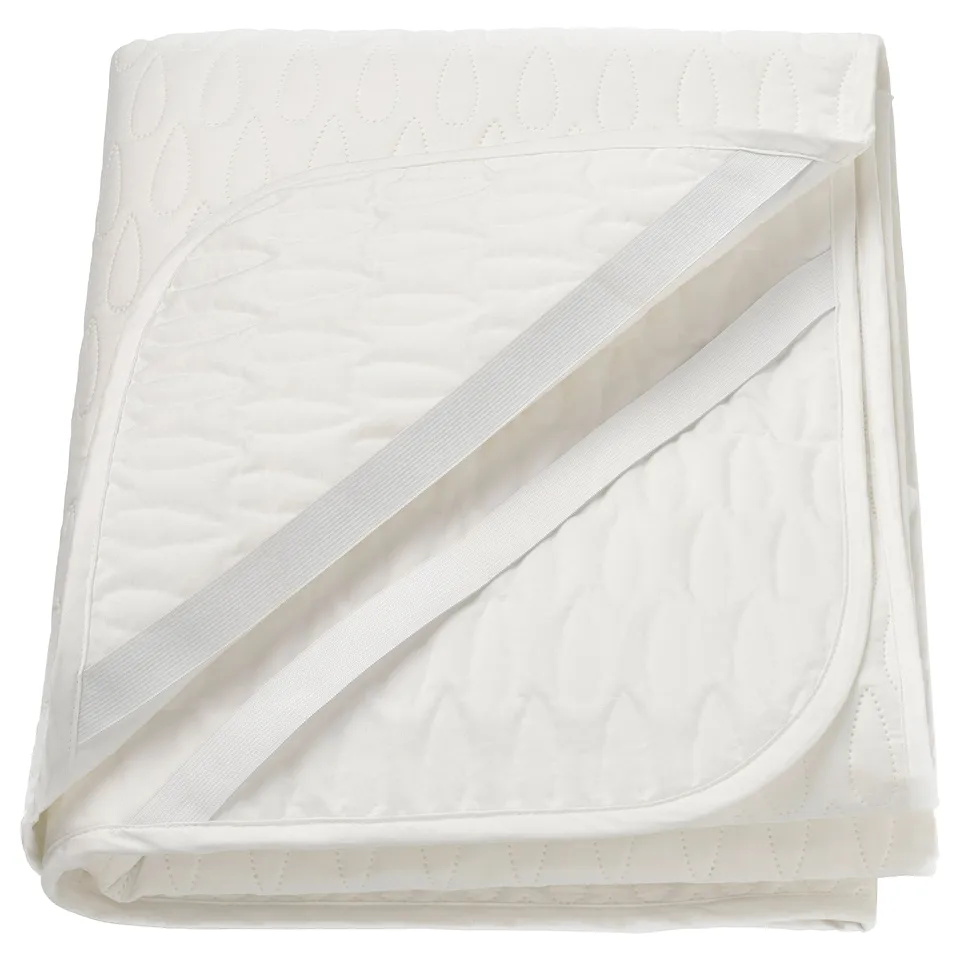 A white SOTNÄTFJÄRIL mattress protector with quilted design and elastic straps for secure fit.