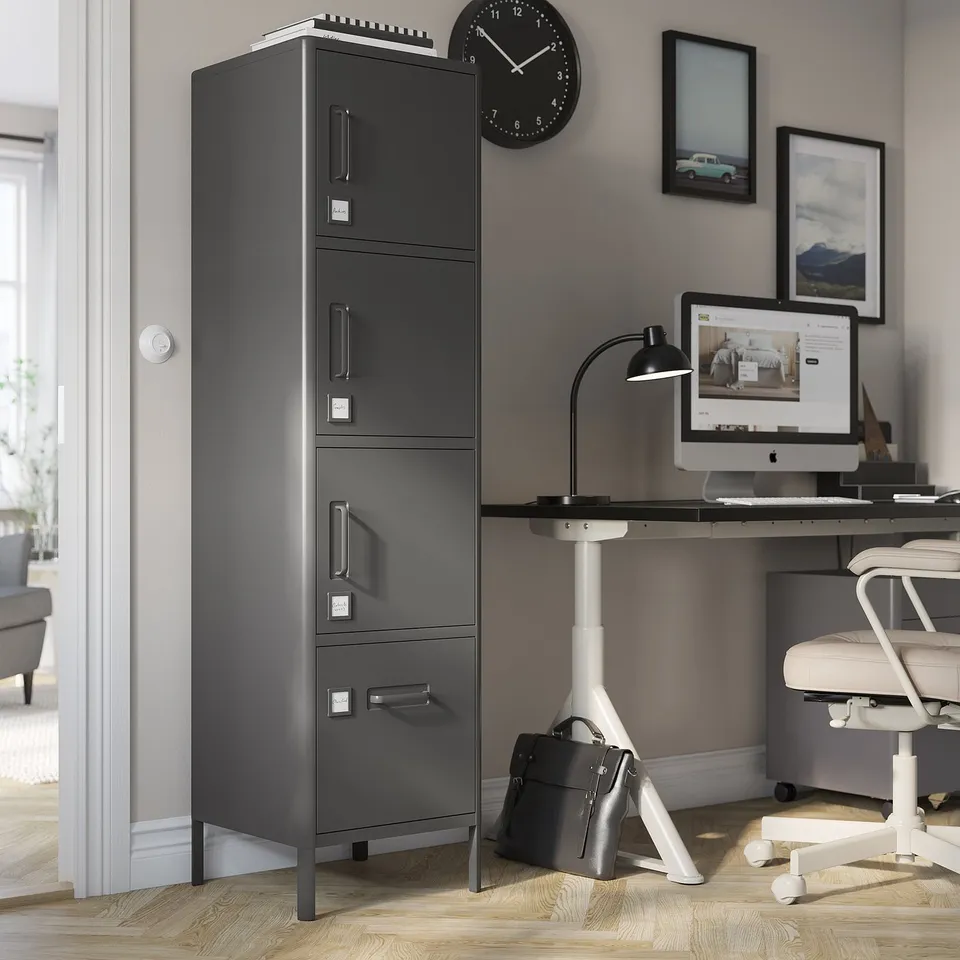 IDÅSEN tall black file cabinet with four drawers in an office setting.