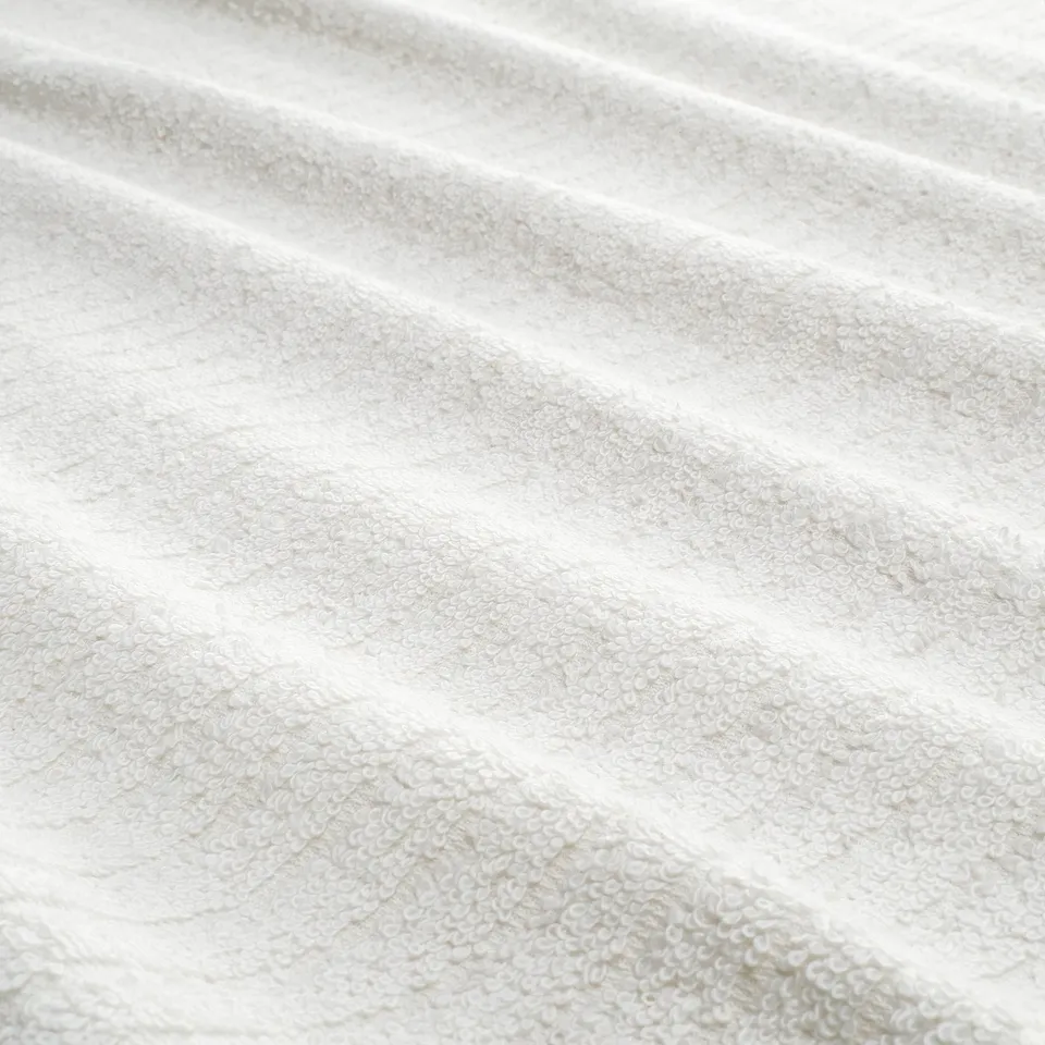 Close-up of a soft, terry cloth towel with distinct stripes, showcasing its textured, absorbent surface.