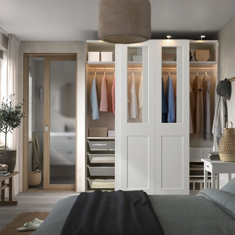 Bedroom with large white PAX wardrobe, bed, and garden door.