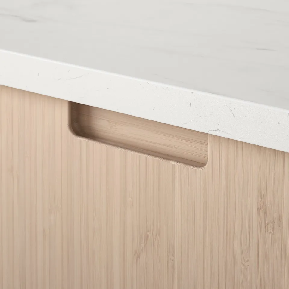 Modern kitchen drawer with natural bamboo finish and sleek white countertop.