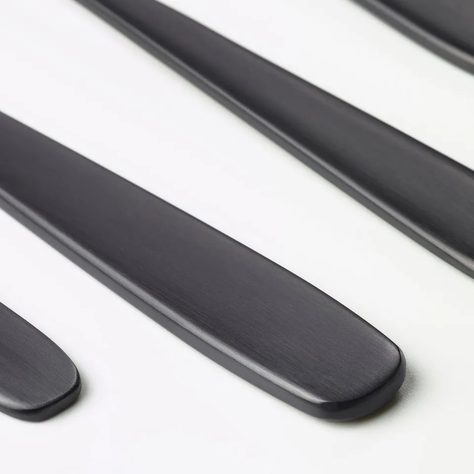 Sleek black cutlery, polished & modern. Well-crafted, visually appealing.