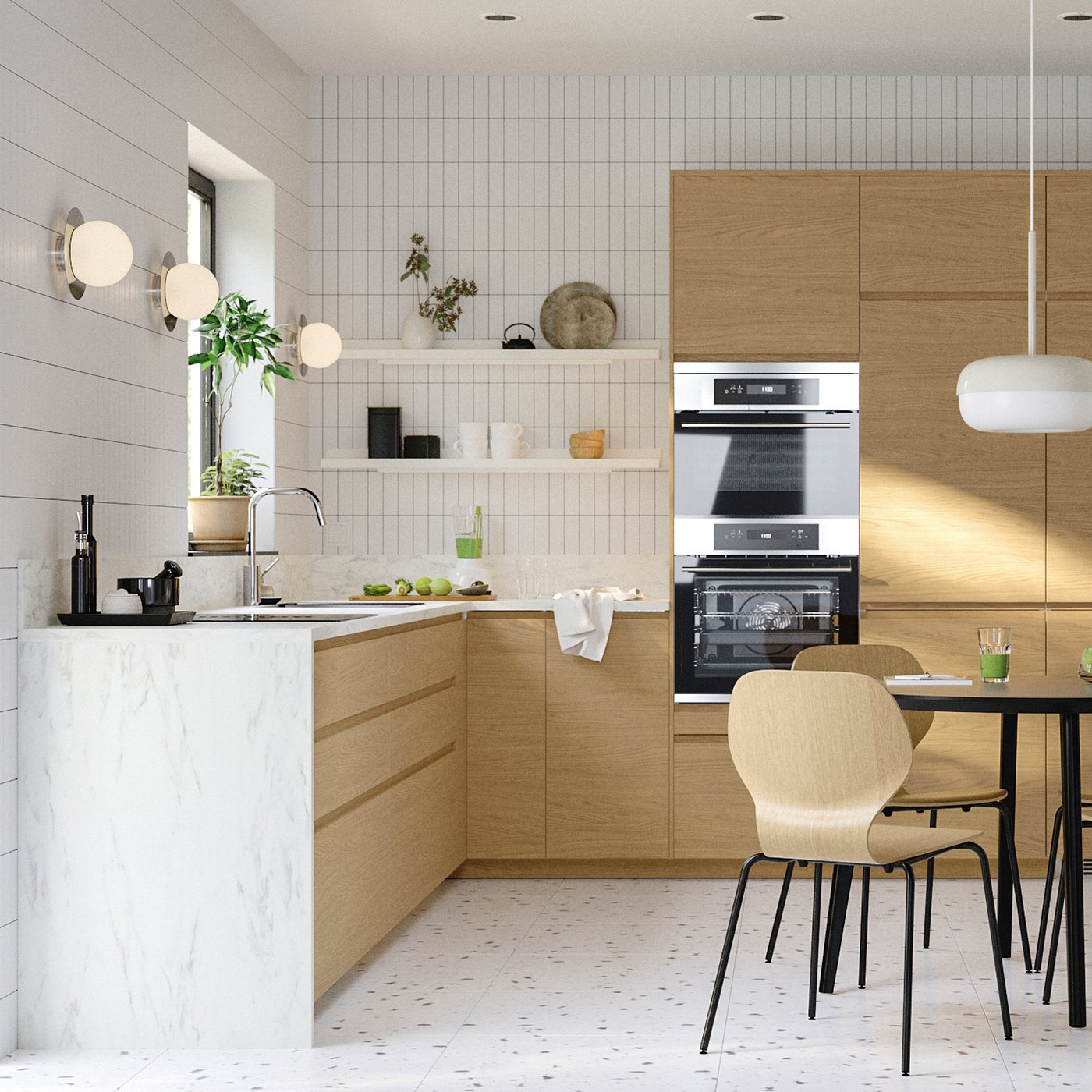 Modern minimalist kitchen with white marble countertops, oak cabinets, built-in oven, and seating area with wooden chairs.