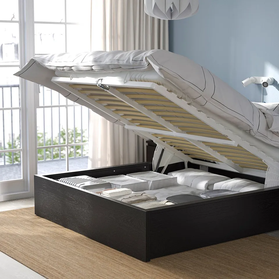 A modern bed with a lift-up base revealing storage space beneath, showcasing its functional design for efficient use of space.