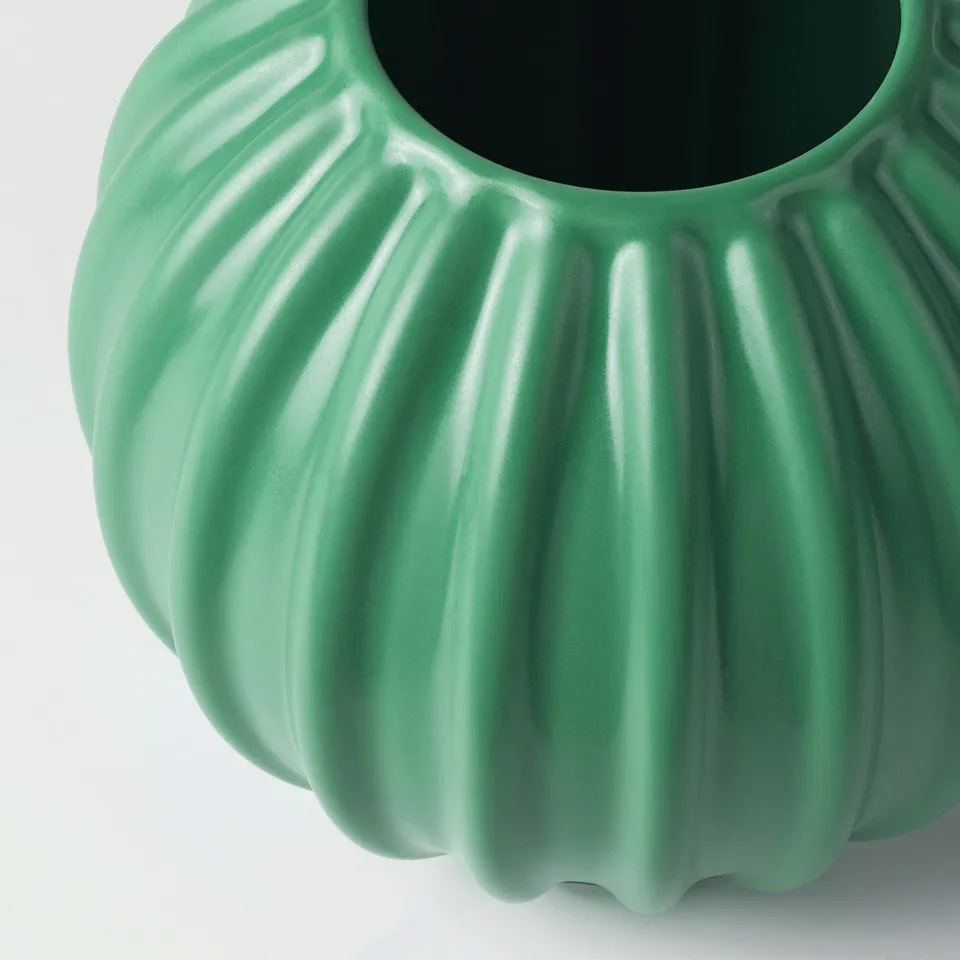 Green glazed stoneware vase with ridged texture, smooth opening, and matte finish.