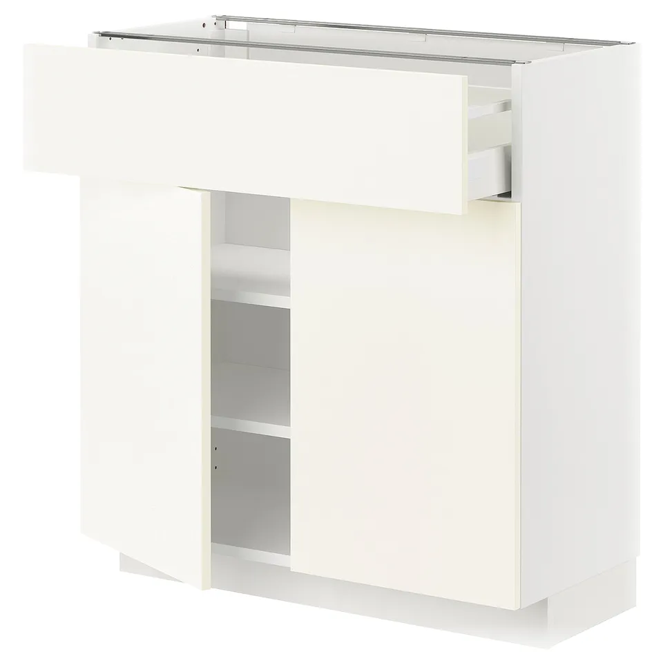 A white METOD kitchen cabinet with a drawer and open shelf. It has a sleek, modern design and is part of the vallstena collection.