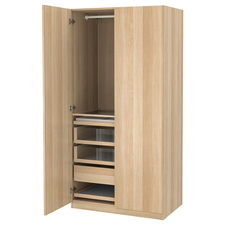 A wooden PAX wardrobe with open doors revealing storage drawers and shelves.