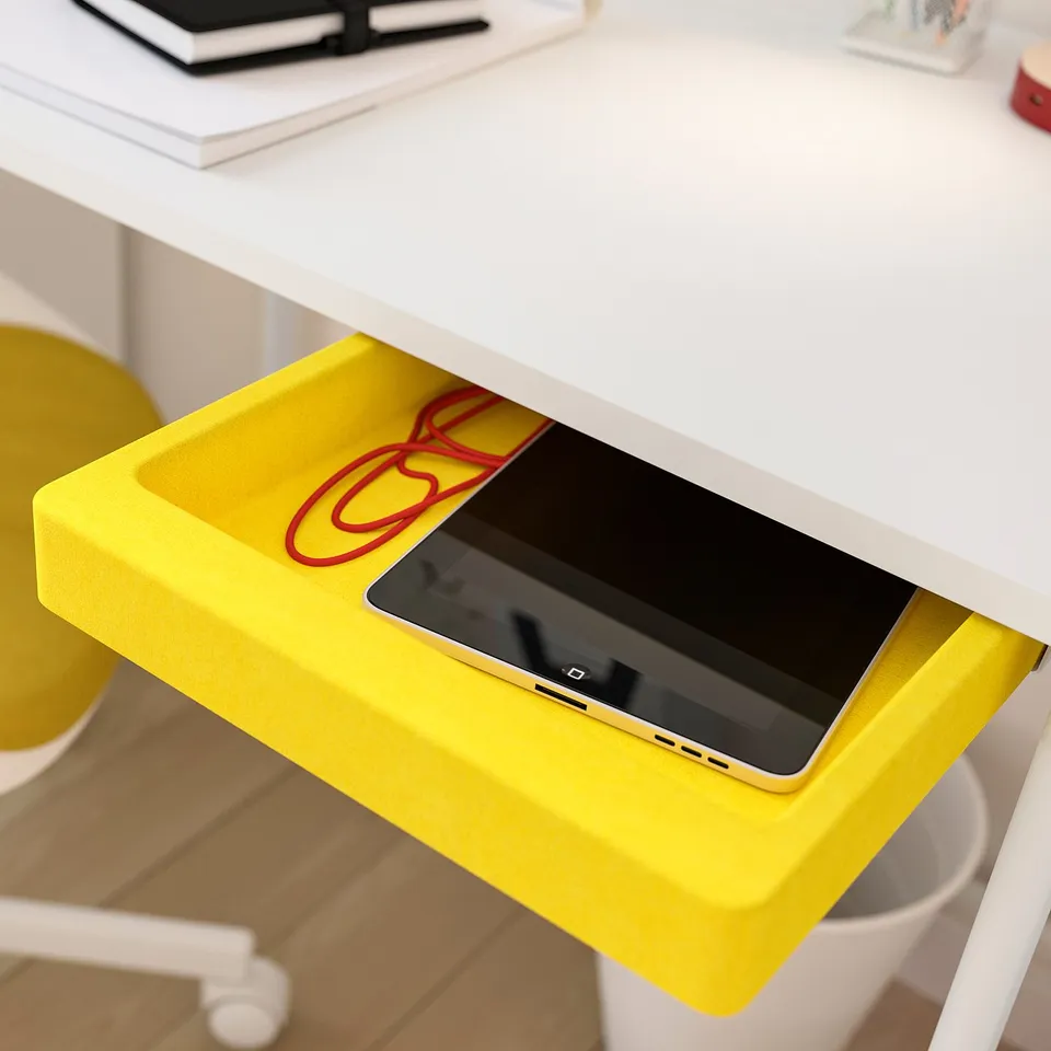 Bright yellow tablet stand on white desk holding ipad and red cable.