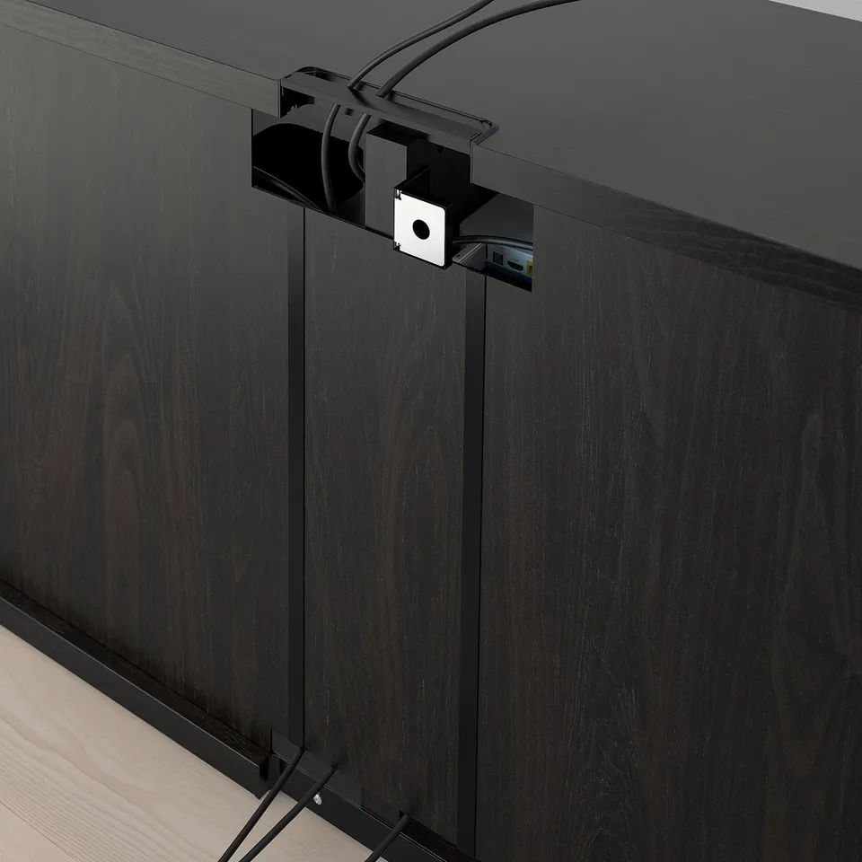 Black tv bench with cable management system visible, featuring adjustable shelves and cable outlets for organised storage.