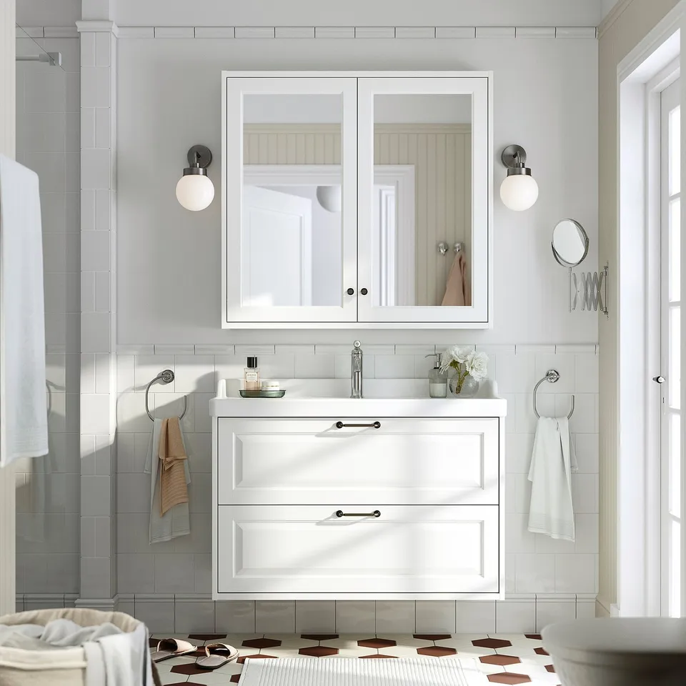 White TÄNNFORSEN vanity with 2 drawers, classic design, under large mirror.