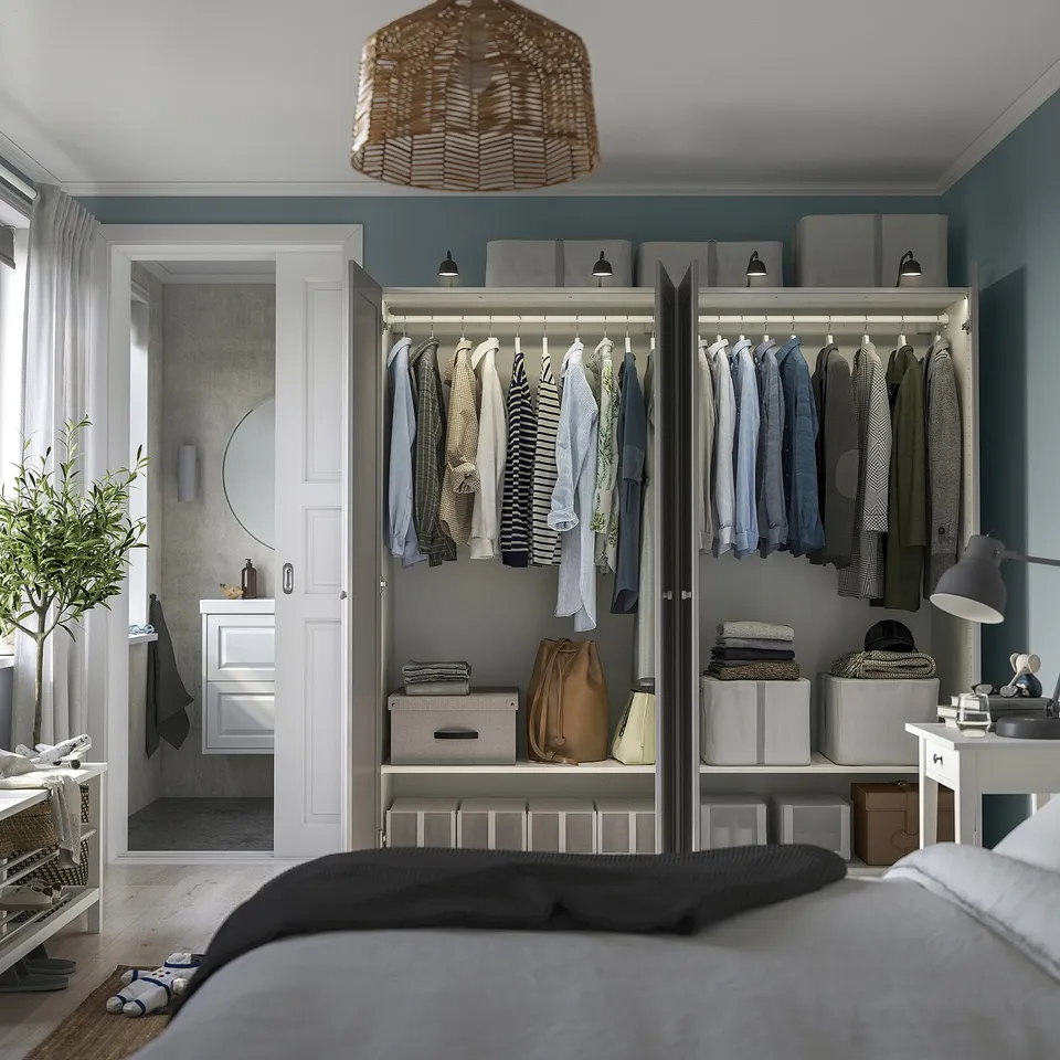 Modern walk-in closet with clothes, shelves, and storage. Integrated lighting for visibility.