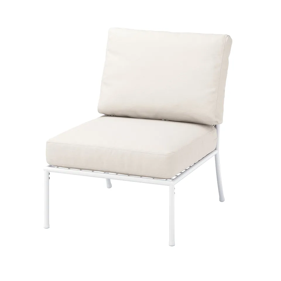 A modern, light beige outdoor armchair with white metal legs. Its sleek, stylish, and appears very comfortable.