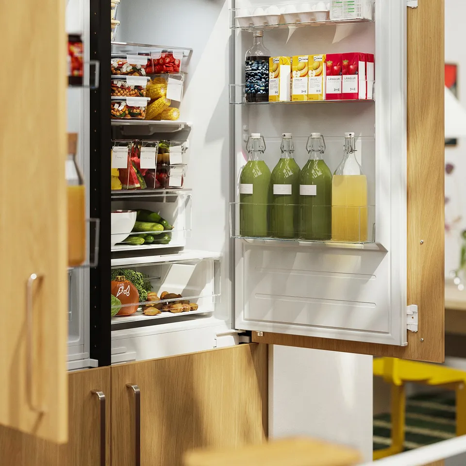 Open fridge with KORKEN bottles, fruit, and veggies; several compartments visible.