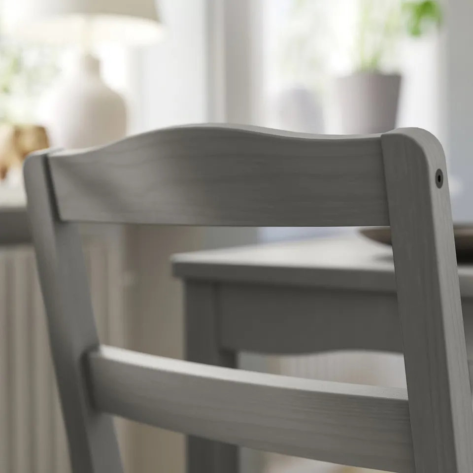 Traditional grey wood chair with ladder-back design. Sturdy and stylish, ideal for dining spaces.
