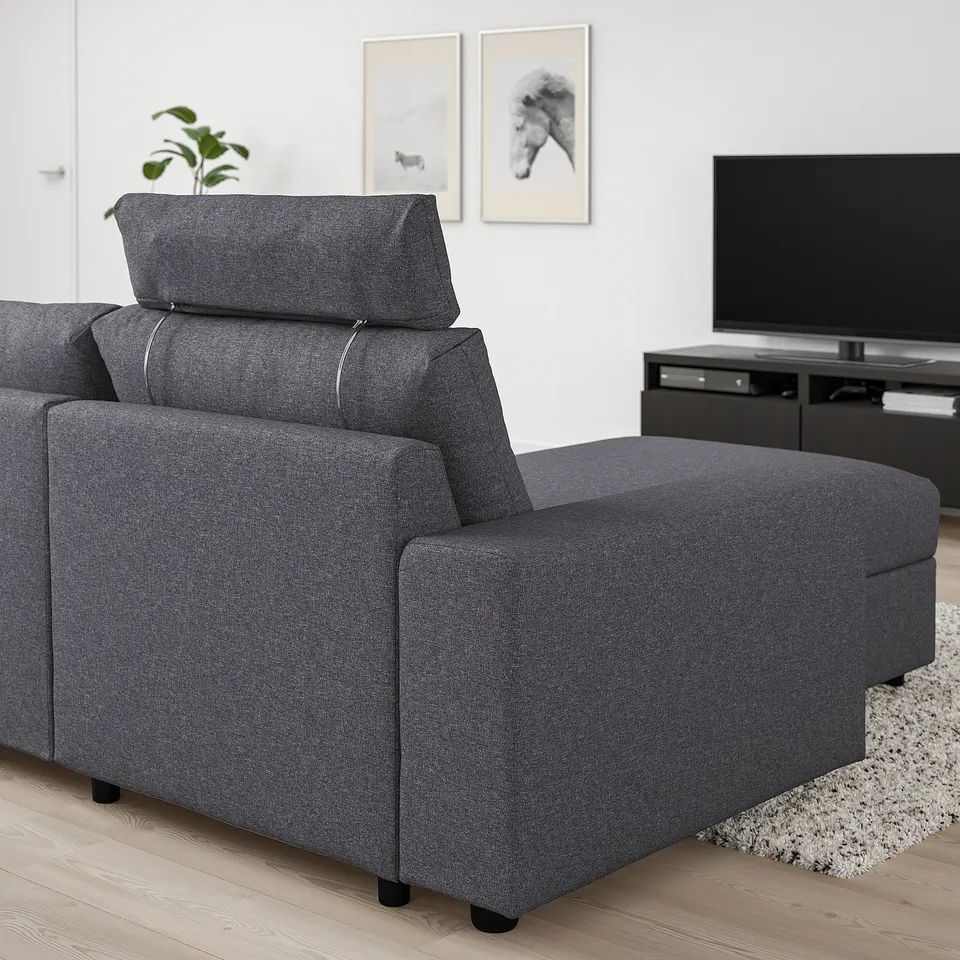 Dark grey VIMLE sofa with ottoman, modern design, fits well in living room.