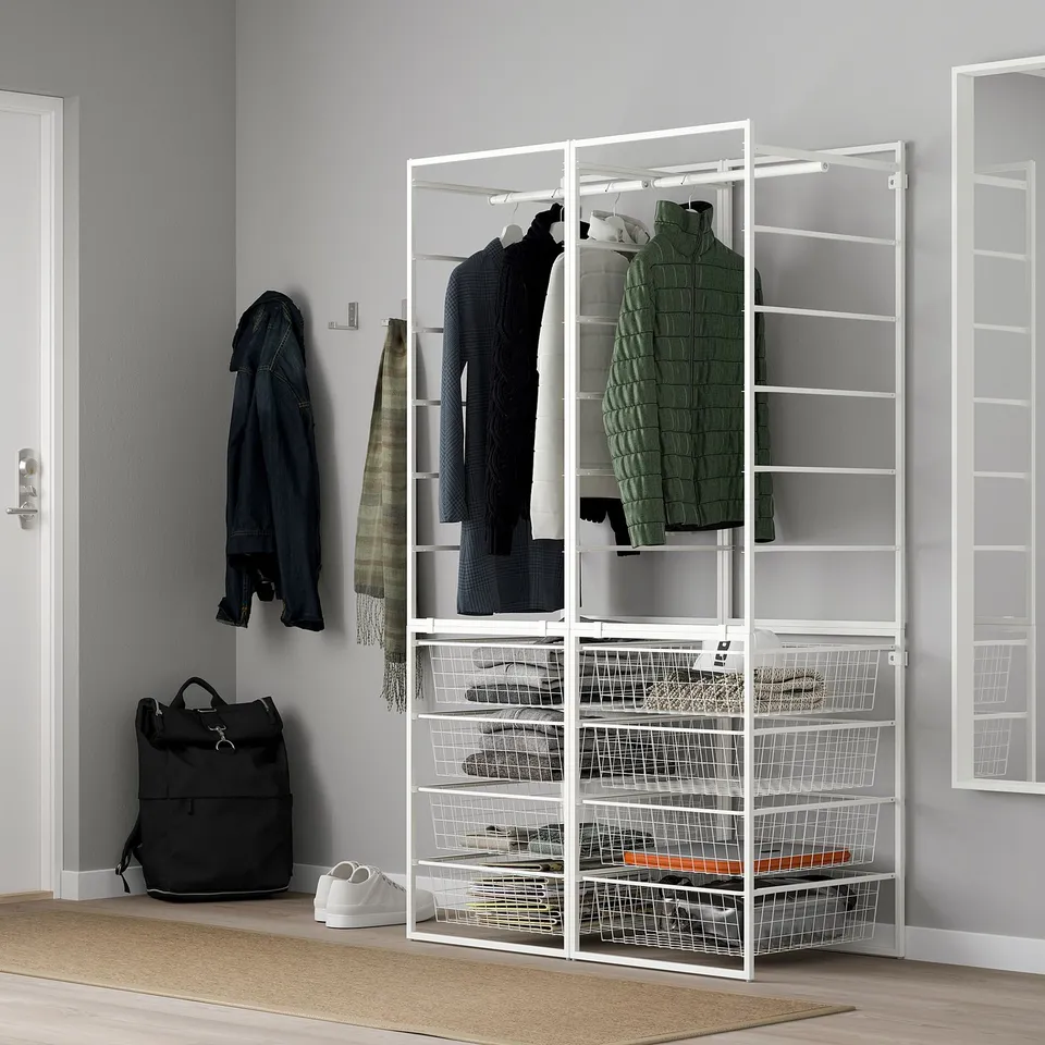 White JONAXEL storage unit organising clothes and accessories in a room.