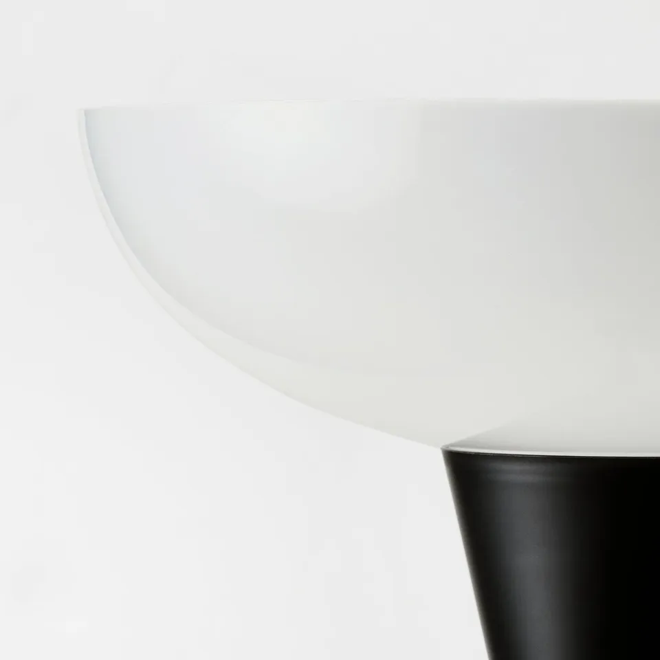 Black and white minimalist lamp; sleek design, curved shade, durable materials.