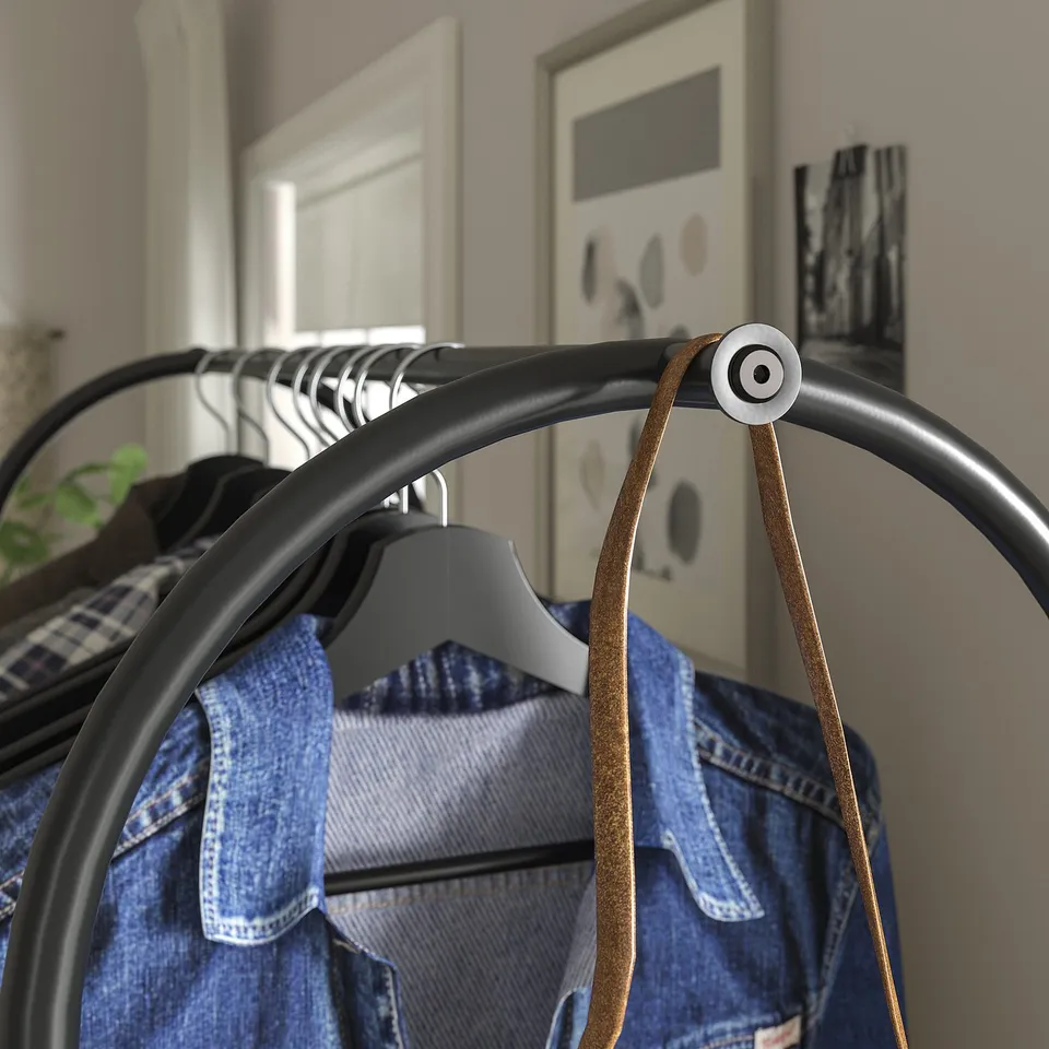 Clothes rack displaying jeans; both ends are hooks, perfect for hanging longer garments. Industrial-style design with metal joints and clean lines.