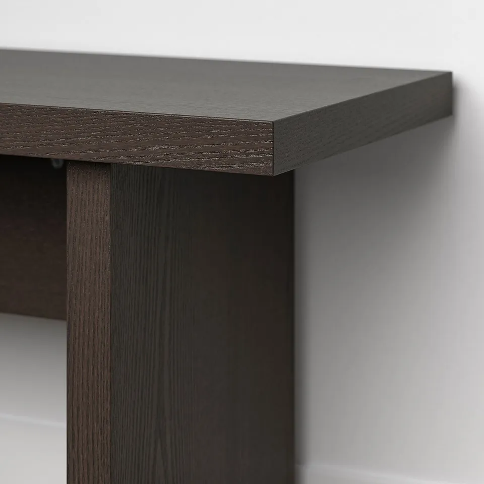 Dark wooden table edge with smooth, even finish and sleek surface.
