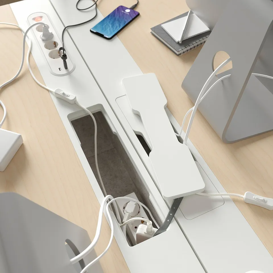 MITTZON adjustable desk with cable management, laptop, and smartphone.