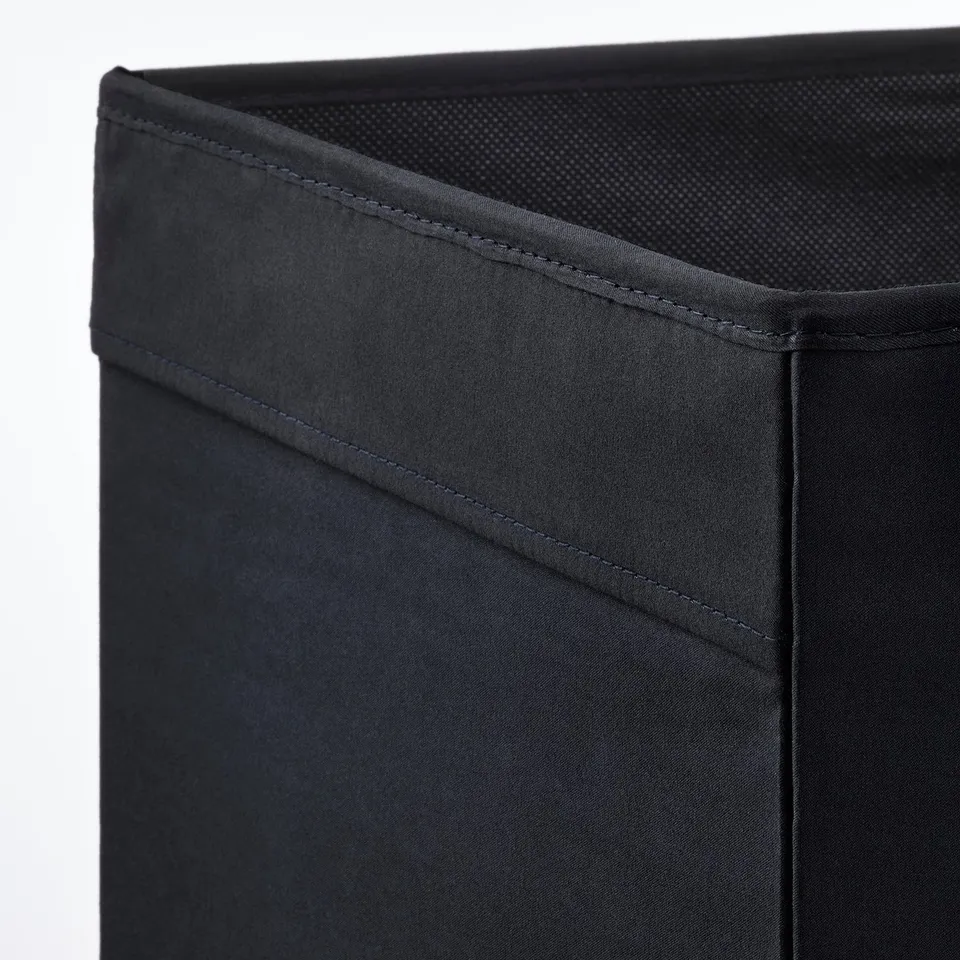 Close-up of a black fabric storage box with sturdy stitching and mesh top, showcasing quality craftsmanship.