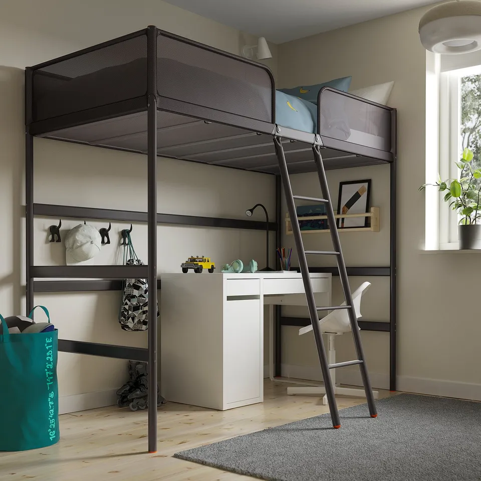 A TUFFING loft bed in black metal and polyester. Compact and sturdy, it fits well in the room with a desk beneath, maximising space.