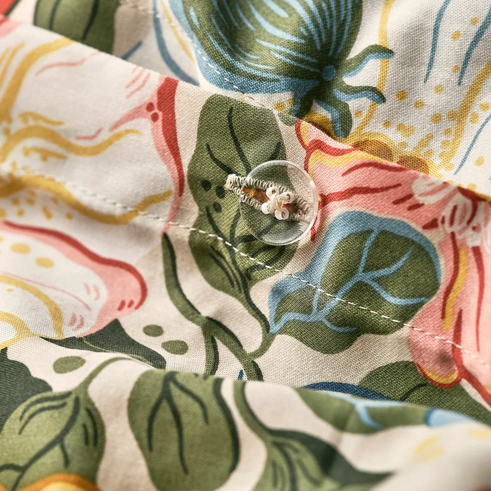 Floral bedding with button closure, showcasing vibrant floral design on soft fabric.