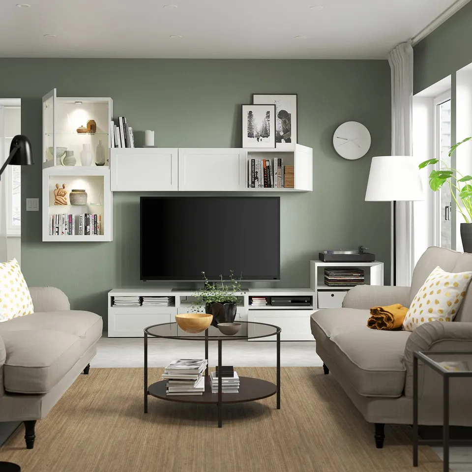 Modern living room with BESTÅ tv storage combo. Adjustable shelves, cable management, and soft-closing drawers. Wall-mounted cabinet above tv.