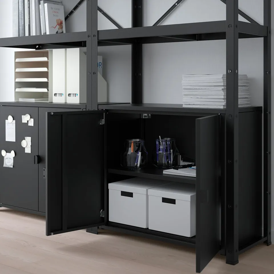 Black metal storage shelves holding white boxes, jars, and papers; sturdy, adjustable, and durable.