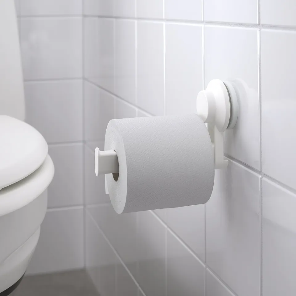 TISKEN holder on tiled wall, with toilet paper, suction cups.