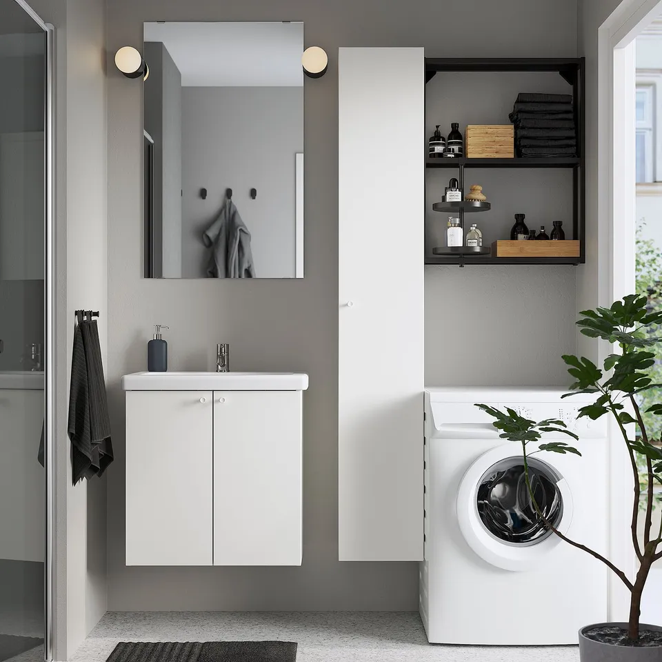 Modern bathroom with white ENHET cabinet, wall sink, mirror, and shelves.
