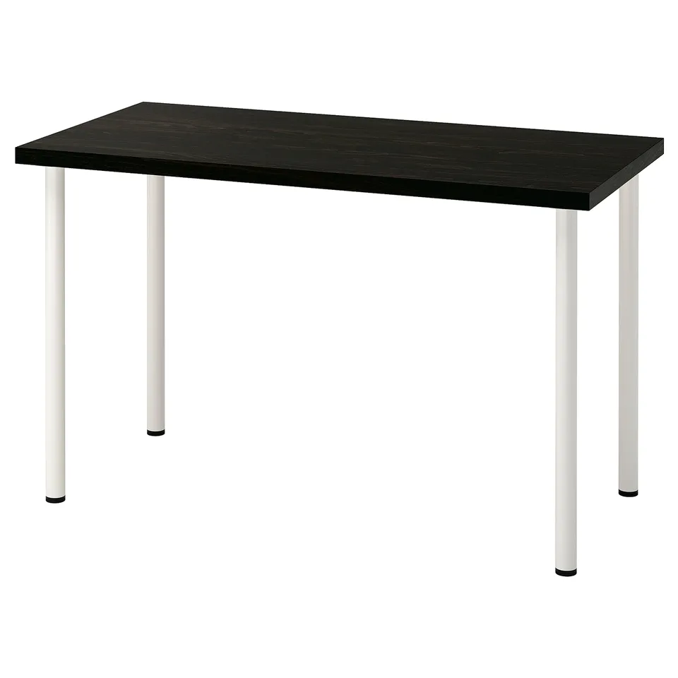 An IKEA LAGKAPTEN desk with a dark brown top and white legs. It has a sleek, modern design with adjustable feet.